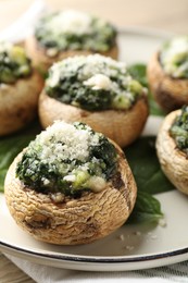 Photo of Tasty stuffed mushrooms served on table, closeup