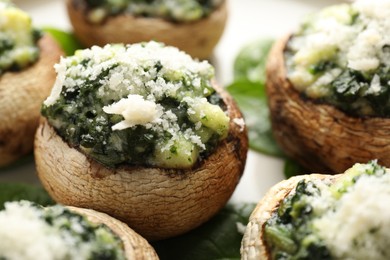 Photo of Tasty stuffed mushrooms served on table, closeup
