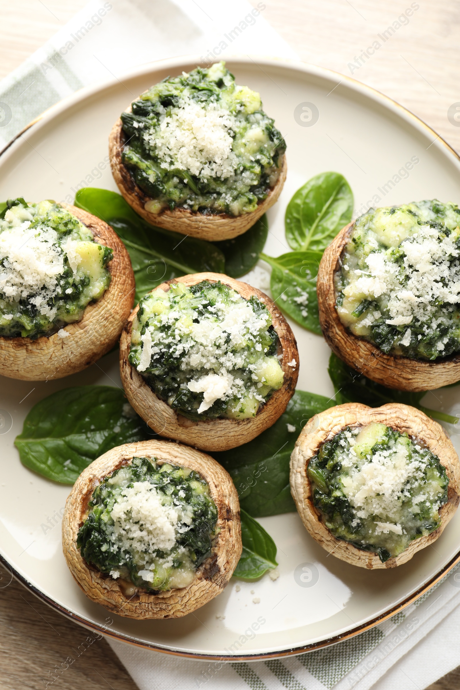 Tasty stuffed mushrooms served on light wooden table, top view Photo of Tasty stuffed mushrooms served on light wooden table, top view