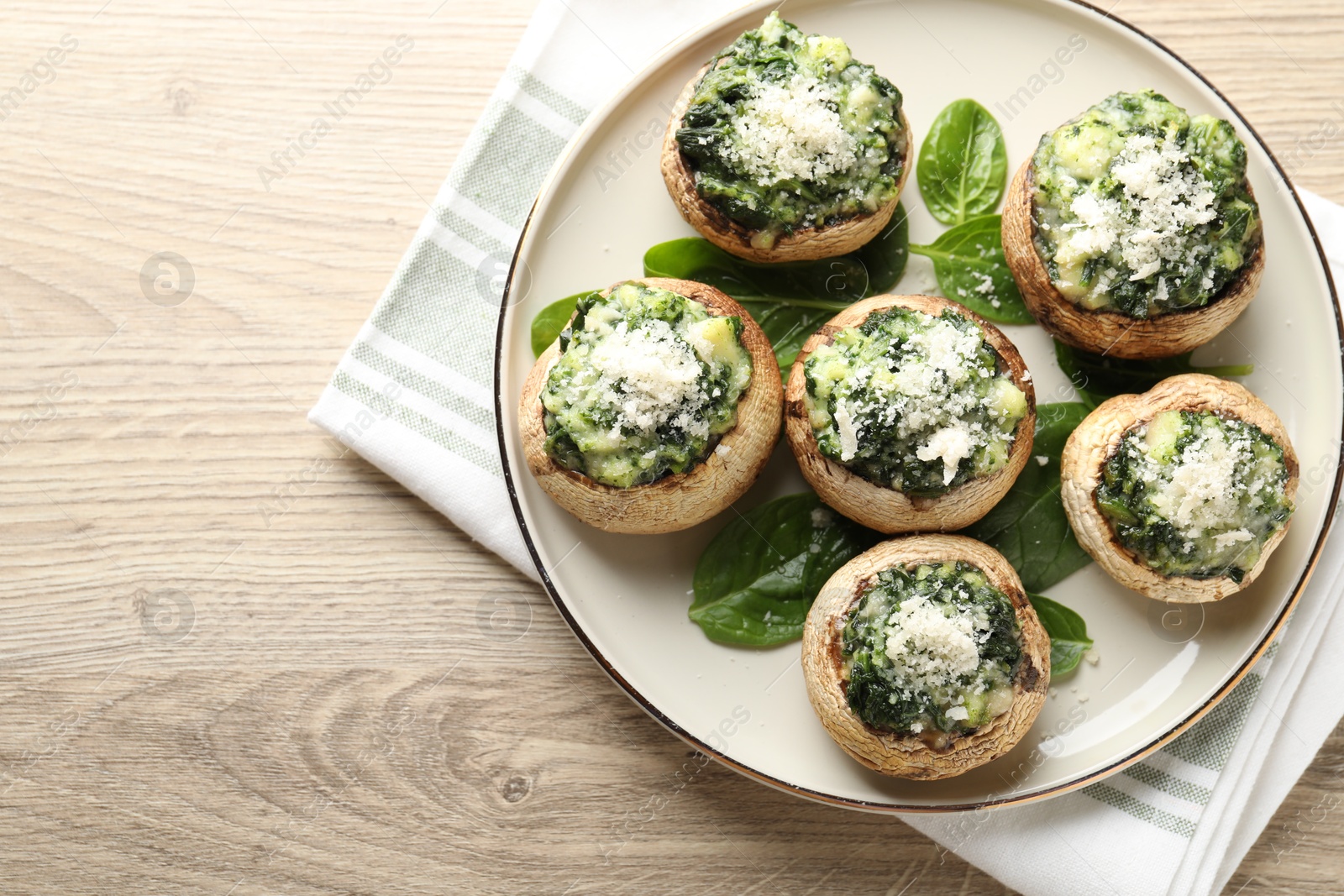 Tasty stuffed mushrooms served on light wooden table, top view. Space for text Photo of Tasty stuffed mushrooms served on light wooden table, top view. Space for text