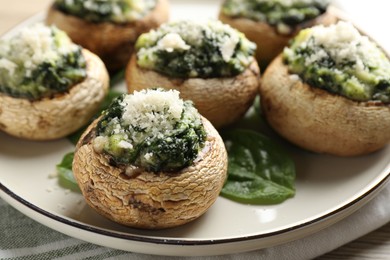 Photo of Tasty stuffed mushrooms served on table, closeup