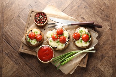 Photo of Tasty stuffed mushrooms served on wooden table, top view