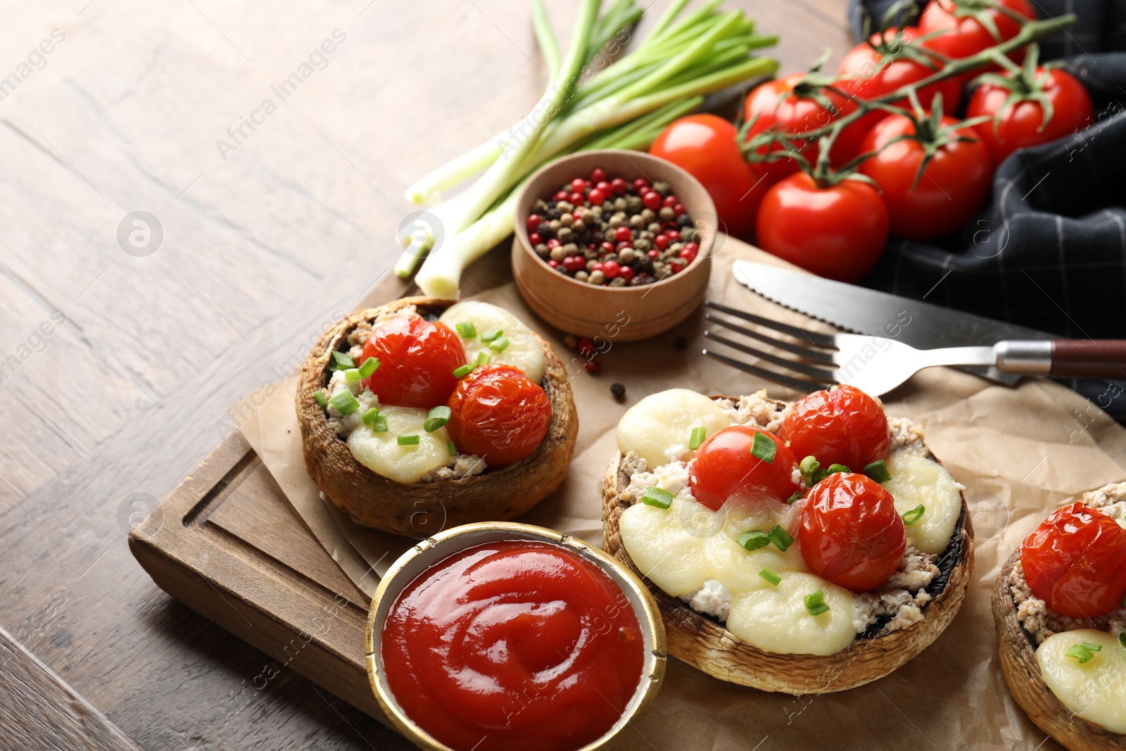 Tasty stuffed mushrooms served on wooden table, closeup Photo of Tasty stuffed mushrooms served on wooden table, closeup