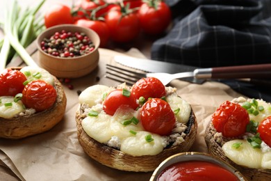 Photo of Tasty stuffed mushrooms served on table, closeup