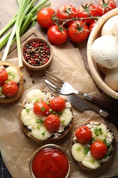 Photo of Tasty stuffed mushrooms served on wooden table, flat lay