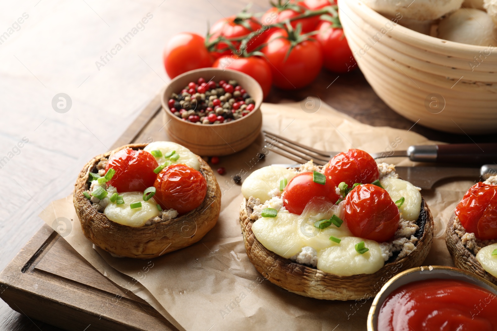 Tasty stuffed mushrooms served on wooden table, closeup Photo of Tasty stuffed mushrooms served on wooden table, closeup