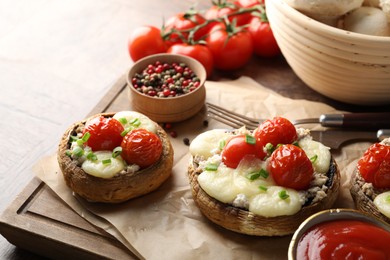Photo of Tasty stuffed mushrooms served on wooden table, closeup