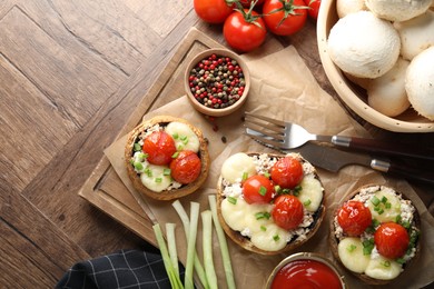 Photo of Tasty stuffed mushrooms served on wooden table, flat lay. Space for text