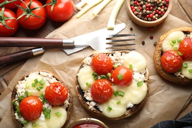 Photo of Tasty stuffed mushrooms served on wooden table, flat lay