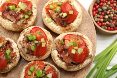 Photo of Tasty stuffed mushrooms served on white table, closeup