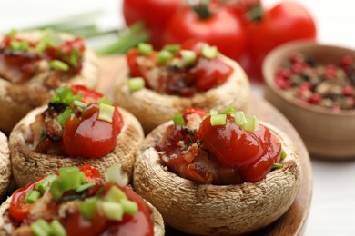 Photo of Tasty stuffed mushrooms served on white table, closeup