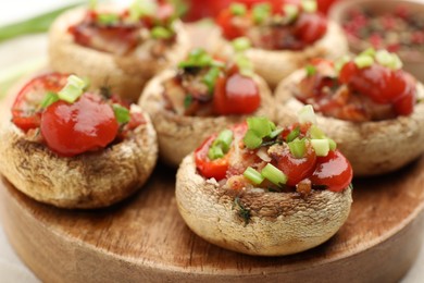 Photo of Tasty stuffed mushrooms served on white table, closeup