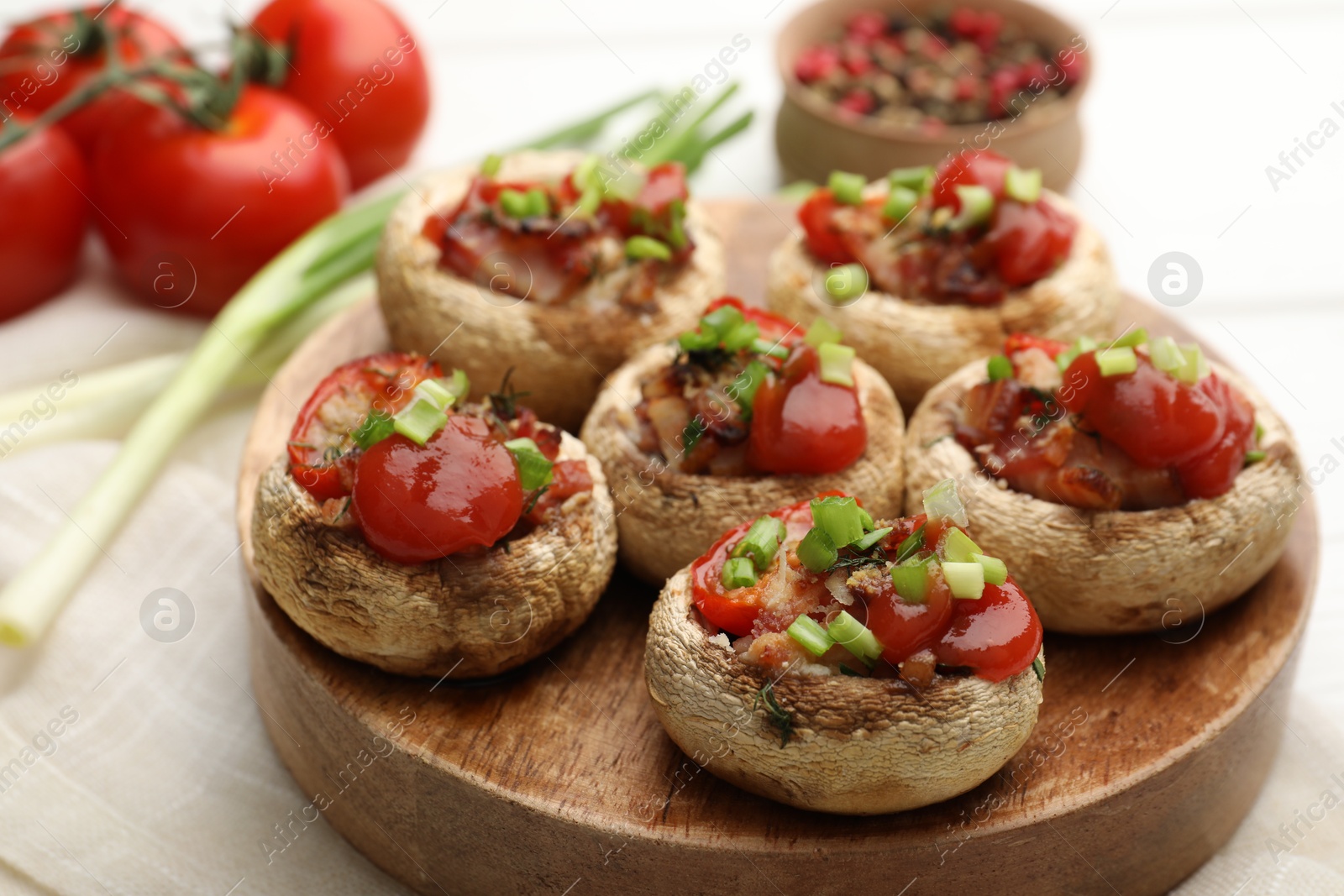 Tasty stuffed mushrooms served on white wooden table, closeup Photo of Tasty stuffed mushrooms served on white wooden table, closeup