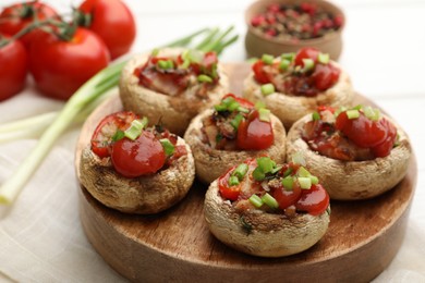 Photo of Tasty stuffed mushrooms served on white wooden table, closeup