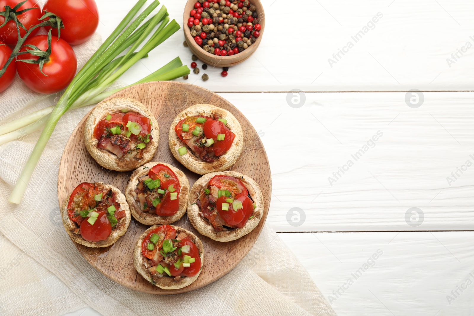 Tasty stuffed mushrooms served on white wooden table, flat lay. Space for text Photo of Tasty stuffed mushrooms served on white wooden table, flat lay. Space for text