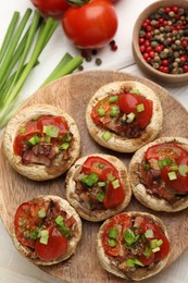 Photo of Tasty stuffed mushrooms served on white wooden table, flat lay