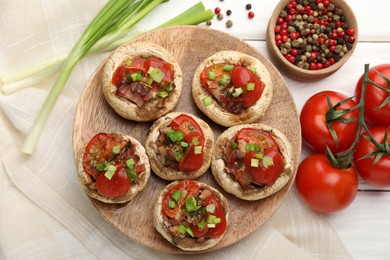 Photo of Tasty stuffed mushrooms served on white wooden table, flat lay