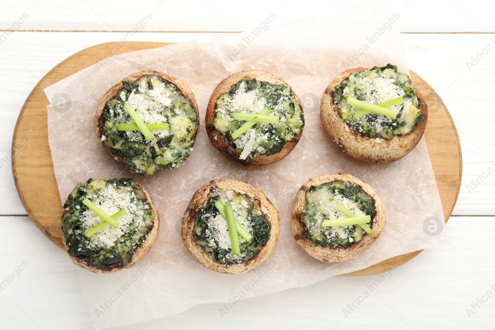 Tasty stuffed mushrooms served on white wooden table, top view Photo of Tasty stuffed mushrooms served on white wooden table, top view