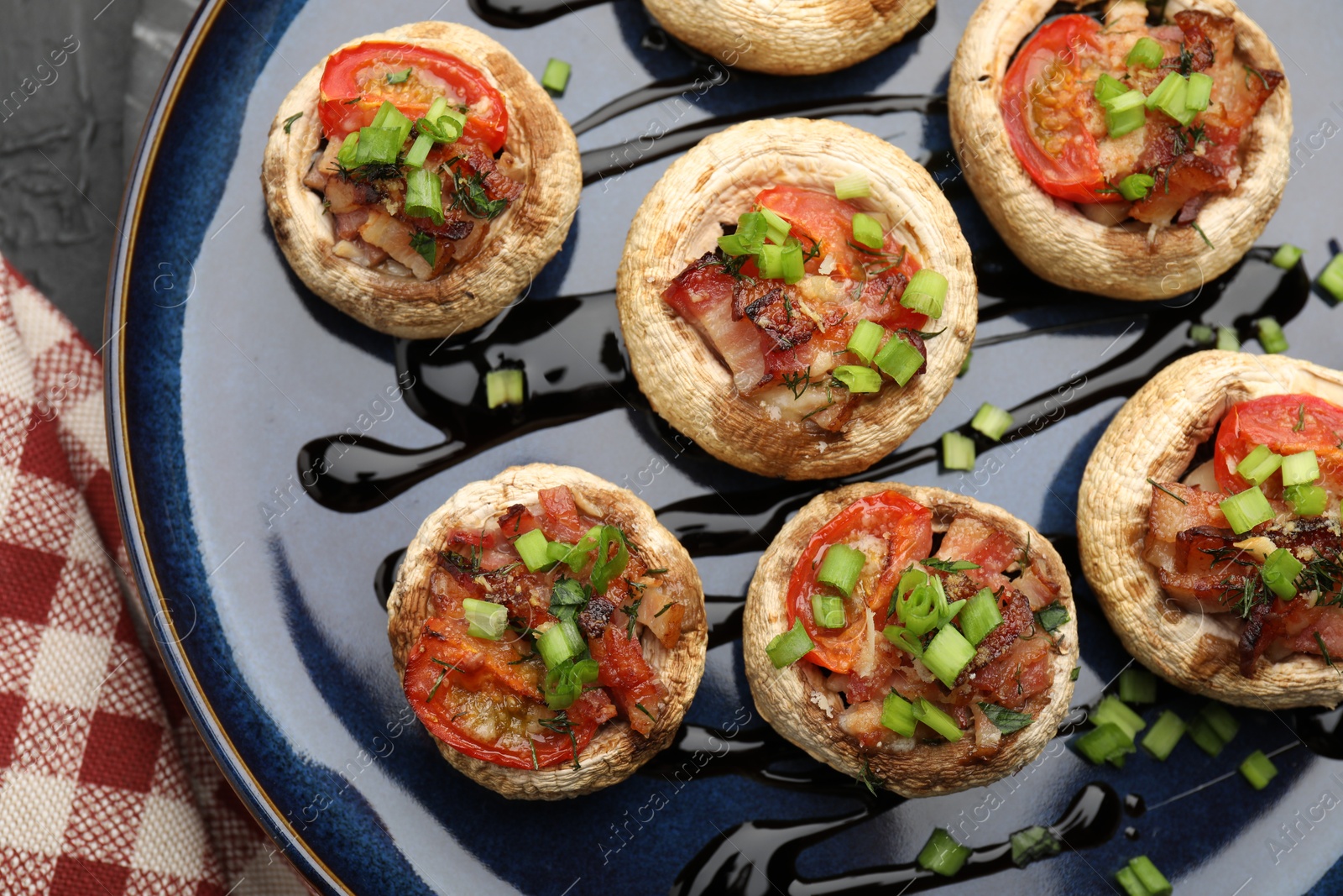 Tasty stuffed mushrooms served on black table, top view Photo of Tasty stuffed mushrooms served on black table, top view