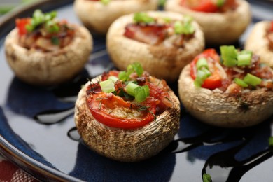 Photo of Tasty stuffed mushrooms served on table, closeup