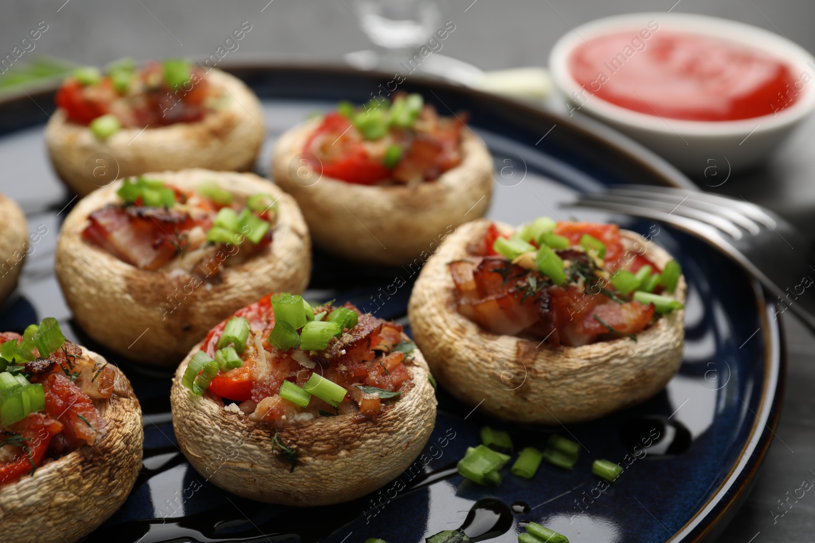 Tasty stuffed mushrooms served on black table, closeup Photo of Tasty stuffed mushrooms served on black table, closeup