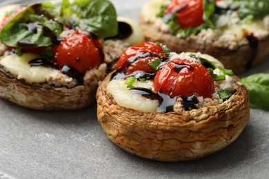 Photo of Tasty stuffed mushrooms served on table, closeup