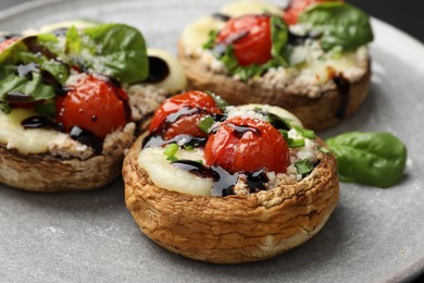 Photo of Tasty stuffed mushrooms served on table, closeup