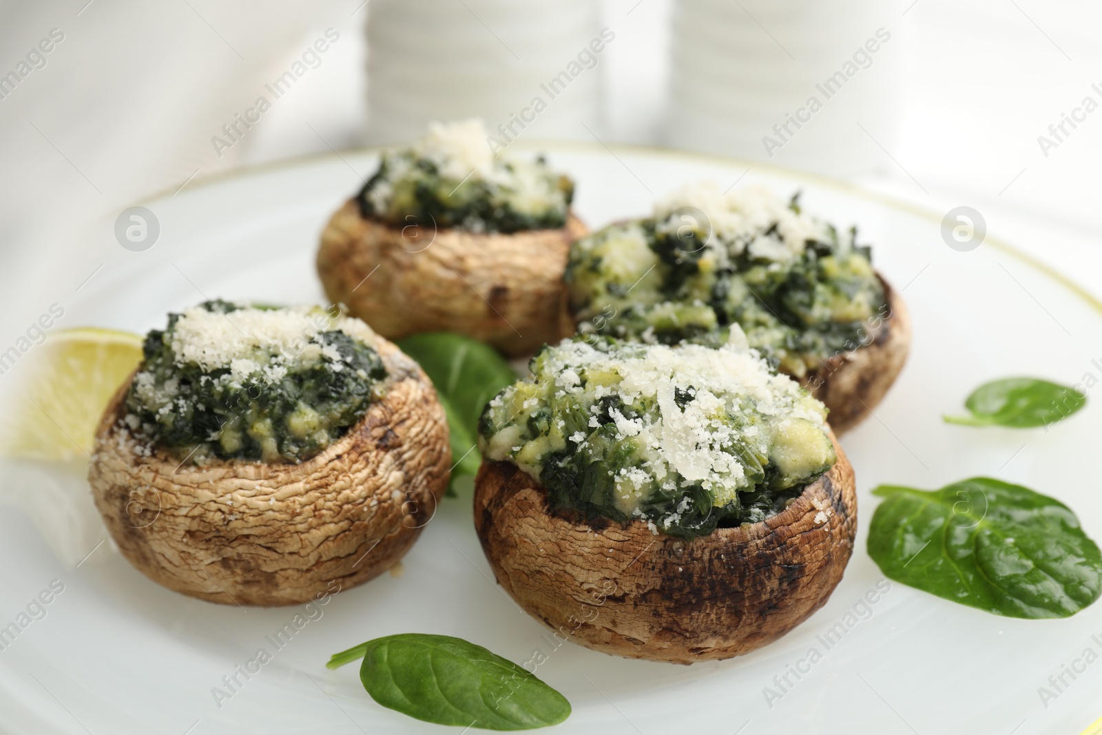Tasty stuffed mushrooms served on white table, closeup Photo of Tasty stuffed mushrooms served on white table, closeup