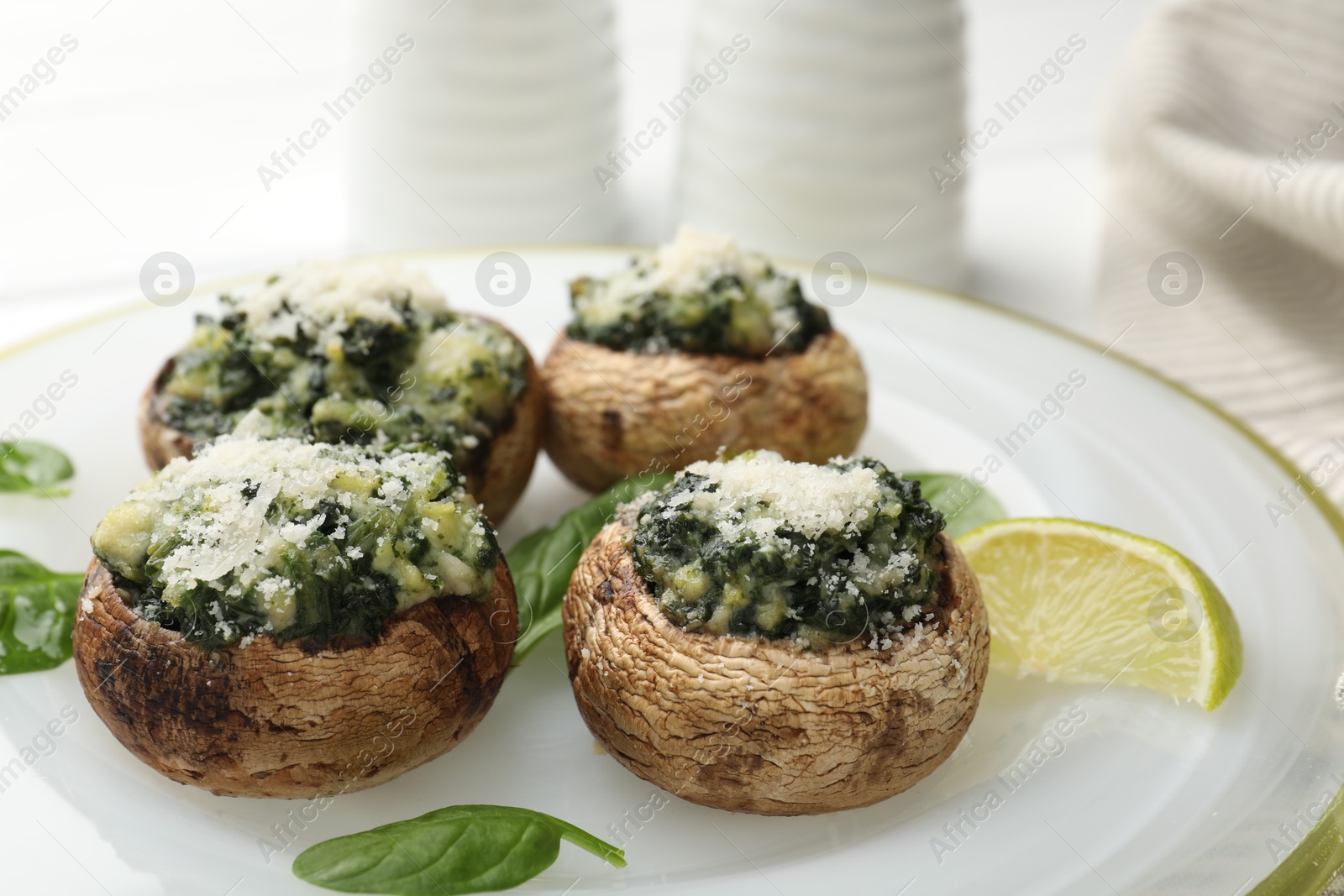 Tasty stuffed mushrooms served on white table, closeup Photo of Tasty stuffed mushrooms served on white table, closeup