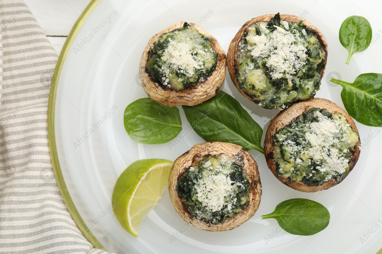 Tasty stuffed mushrooms served on white table, top view Photo of Tasty stuffed mushrooms served on white table, top view