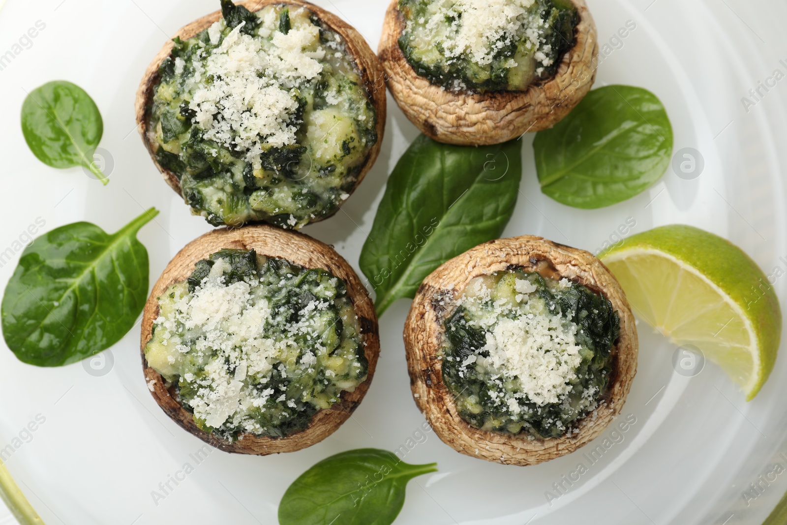 Tasty stuffed mushrooms on plate, top view Photo of Tasty stuffed mushrooms on plate, top view