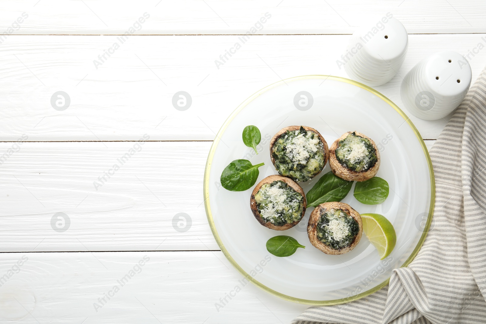 Tasty stuffed mushrooms served on white wooden table, top view. Space for text Photo of Tasty stuffed mushrooms served on white wooden table, top view. Space for text