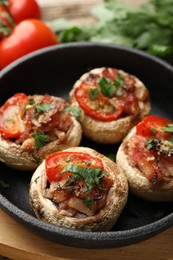 Photo of Tasty stuffed mushrooms served on table, closeup