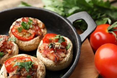 Photo of Tasty stuffed mushrooms served on table, closeup