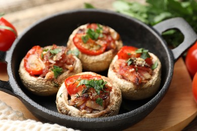 Photo of Tasty stuffed mushrooms served on table, closeup
