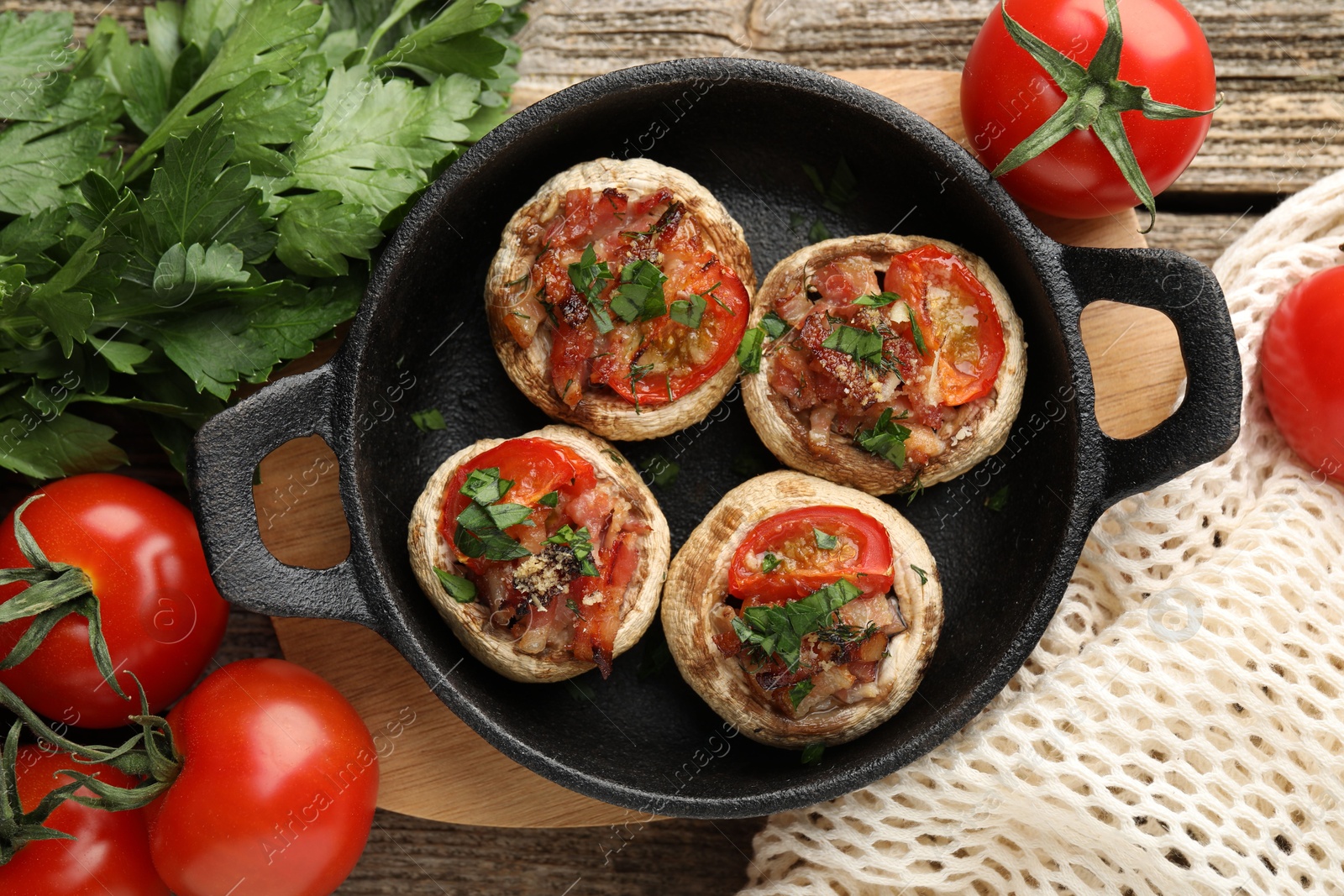 Tasty stuffed mushrooms served on wooden table, flat lay Photo of Tasty stuffed mushrooms served on wooden table, flat lay