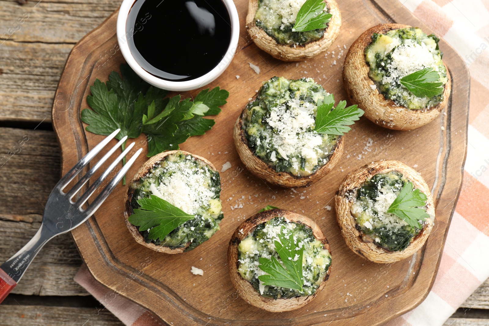 Tasty stuffed mushrooms served on wooden table, top view Photo of Tasty stuffed mushrooms served on wooden table, top view
