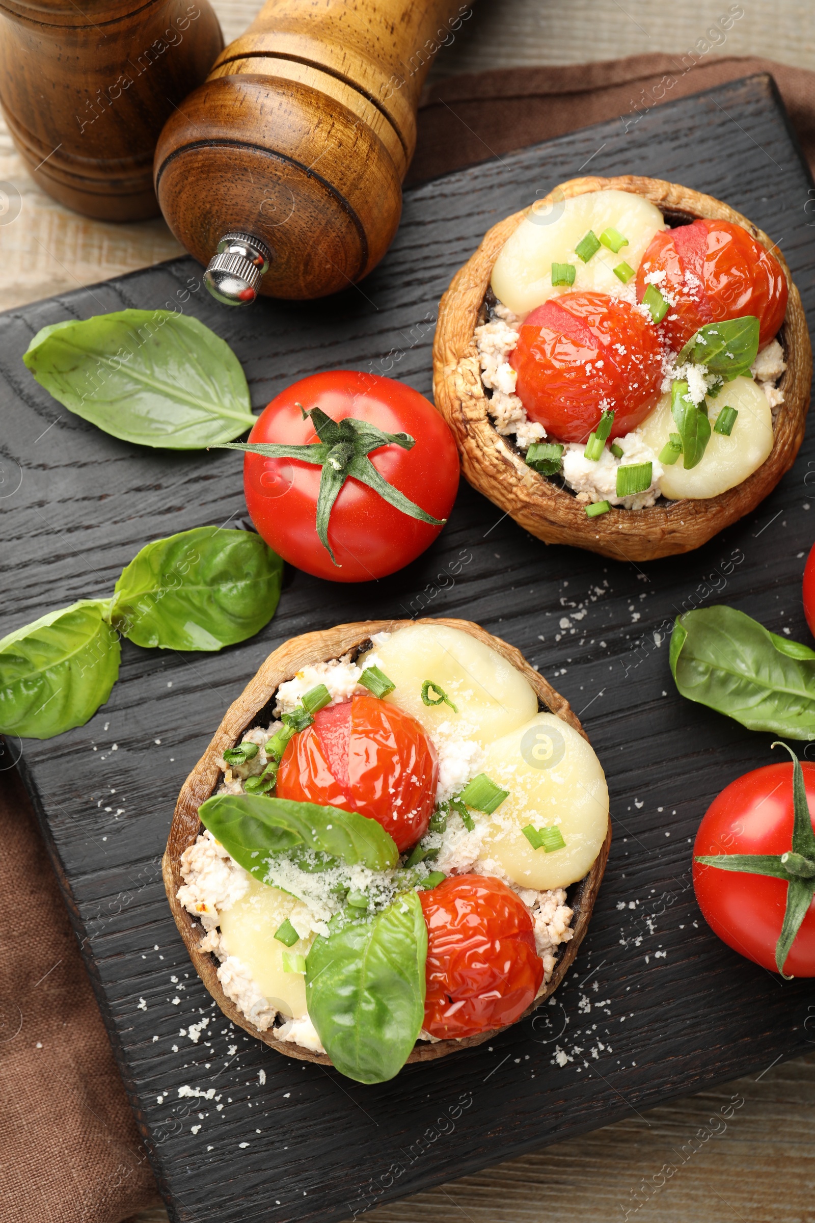 Tasty stuffed mushrooms served on wooden table, top view Photo of Tasty stuffed mushrooms served on wooden table, top view