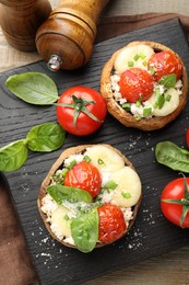 Photo of Tasty stuffed mushrooms served on wooden table, top view