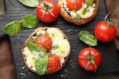 Photo of Tasty stuffed mushrooms served on wooden table, top view