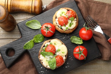 Photo of Tasty stuffed mushrooms served on wooden table, top view