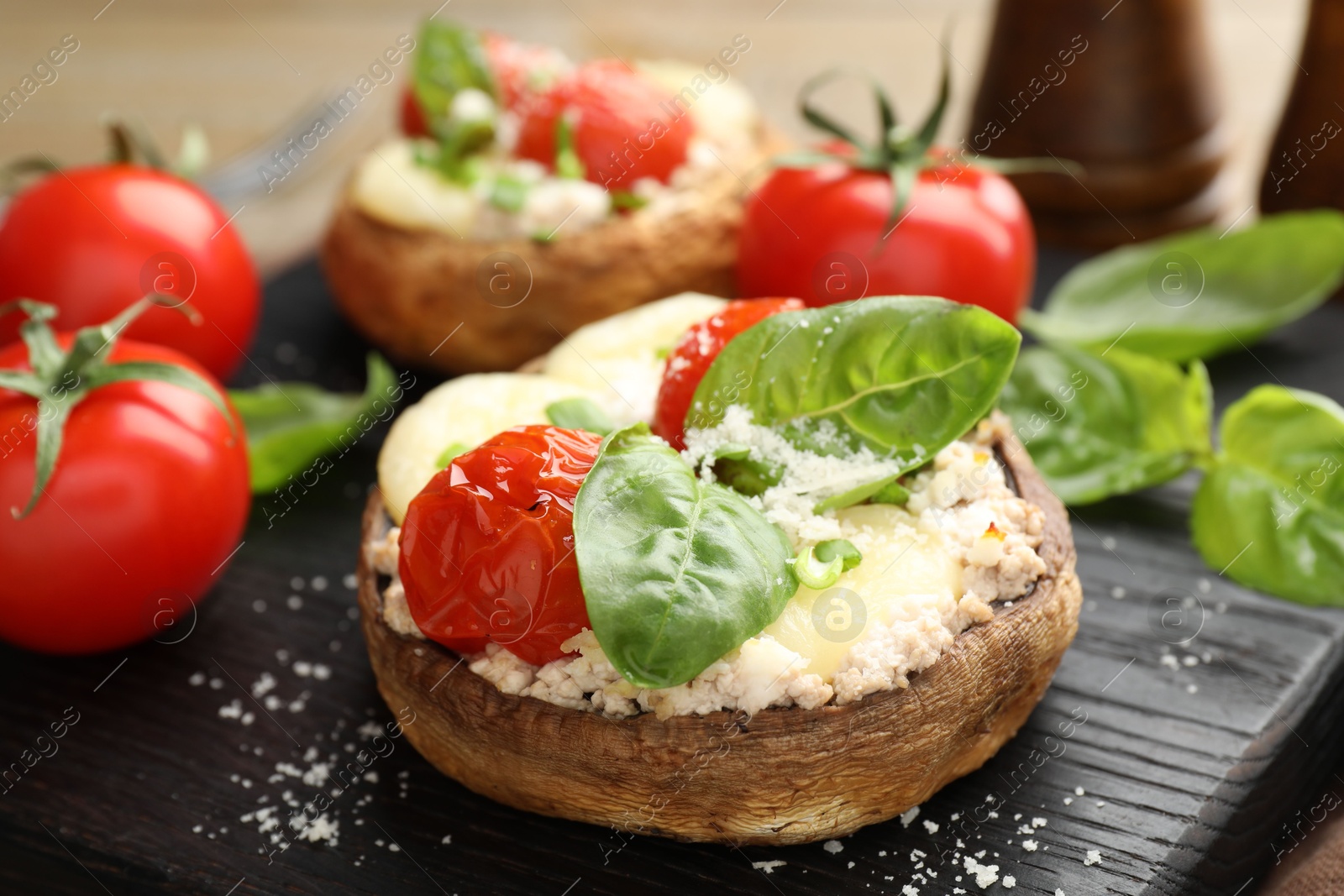 Tasty stuffed mushrooms served on wooden table, closeup Photo of Tasty stuffed mushrooms served on wooden table, closeup