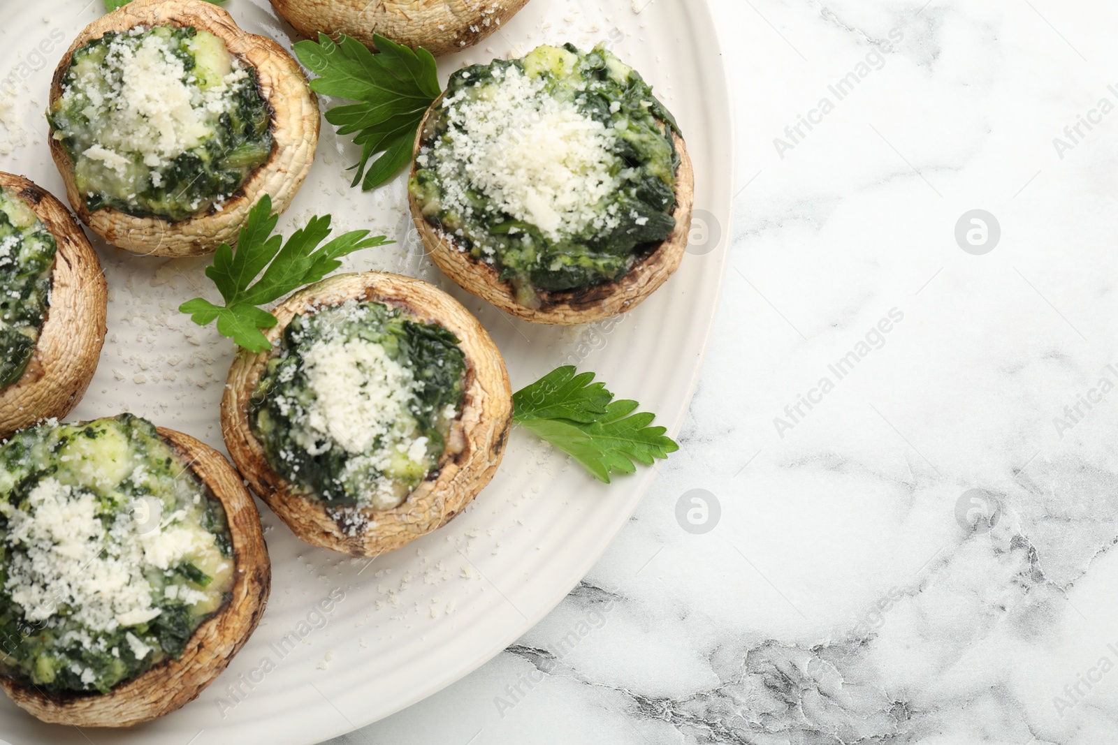 Tasty stuffed mushrooms served on white marble table, top view. Space for text Photo of Tasty stuffed mushrooms served on white marble table, top view. Space for text