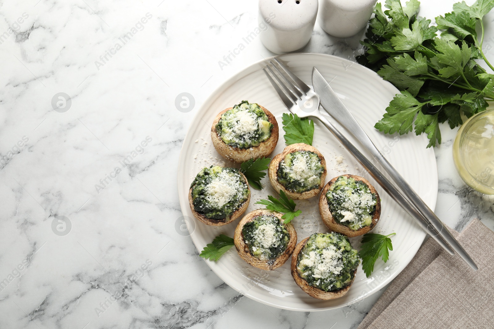 Tasty stuffed mushrooms served on white marble table, flat lay. Space for text Photo of Tasty stuffed mushrooms served on white marble table, flat lay. Space for text