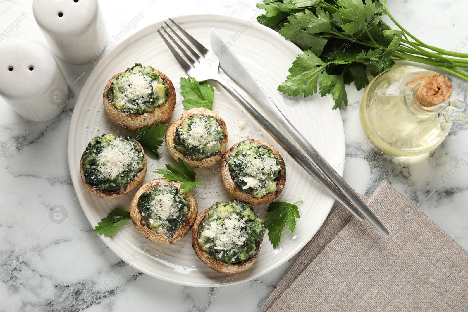 Tasty stuffed mushrooms served on white marble table, flat lay Photo of Tasty stuffed mushrooms served on white marble table, flat lay
