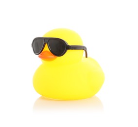 Photo of One cute rubber duck in sunglasses on mirror surface against white background