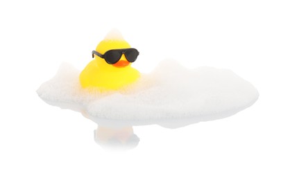 Photo of One cute rubber duck in sunglasses and foam on mirror surface against white background