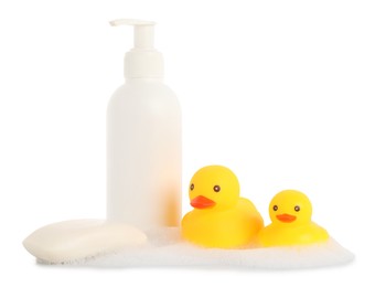 Photo of Cute rubber ducks, soap bar, bottle and foam isolated on white