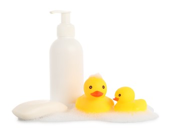 Photo of Cute rubber ducks, soap bar, bottle and foam isolated on white