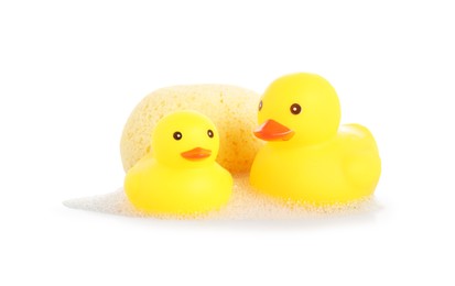 Photo of Cute rubber ducks and sponge with foam isolated on white